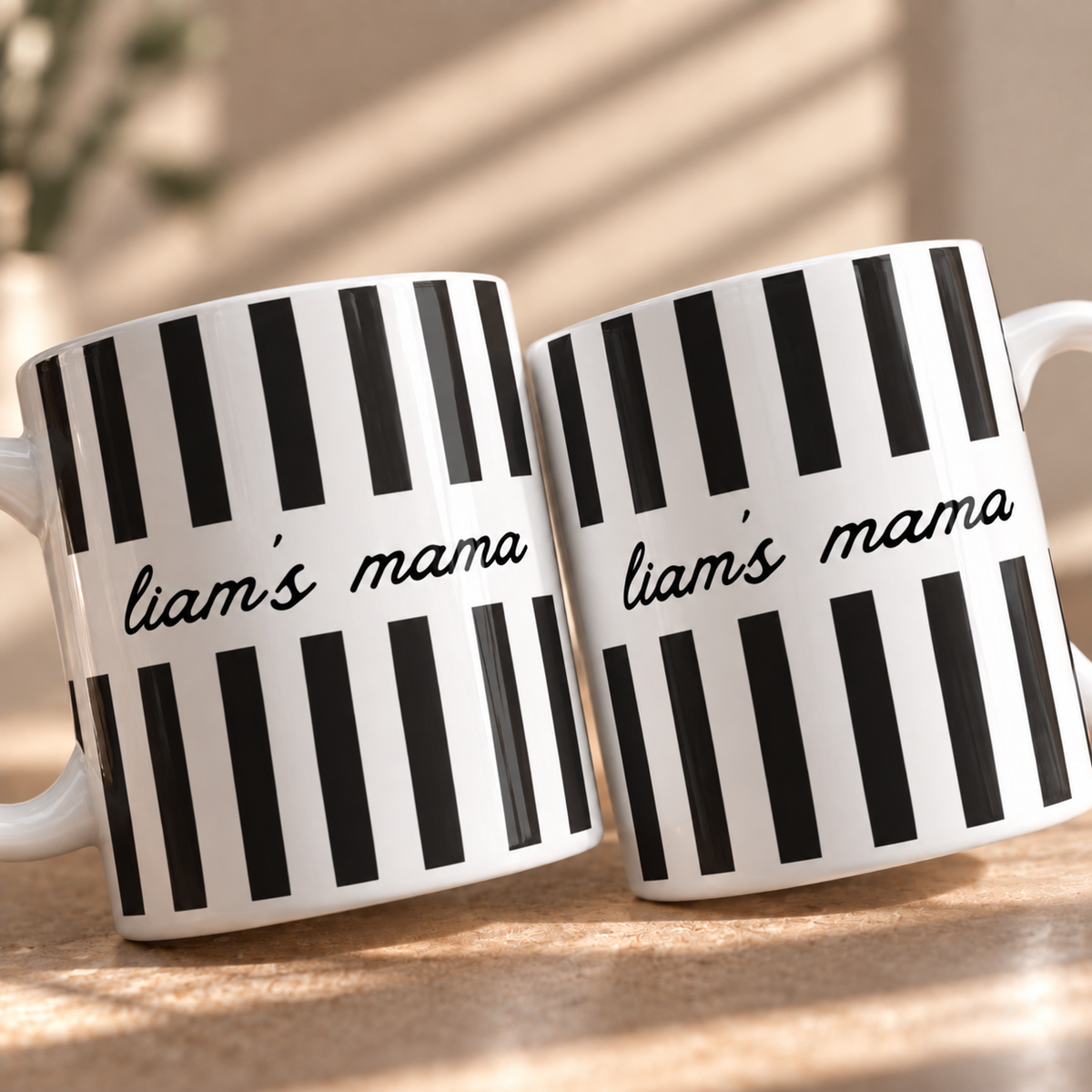 Close up of custom Mama mug with child name and black stripes
