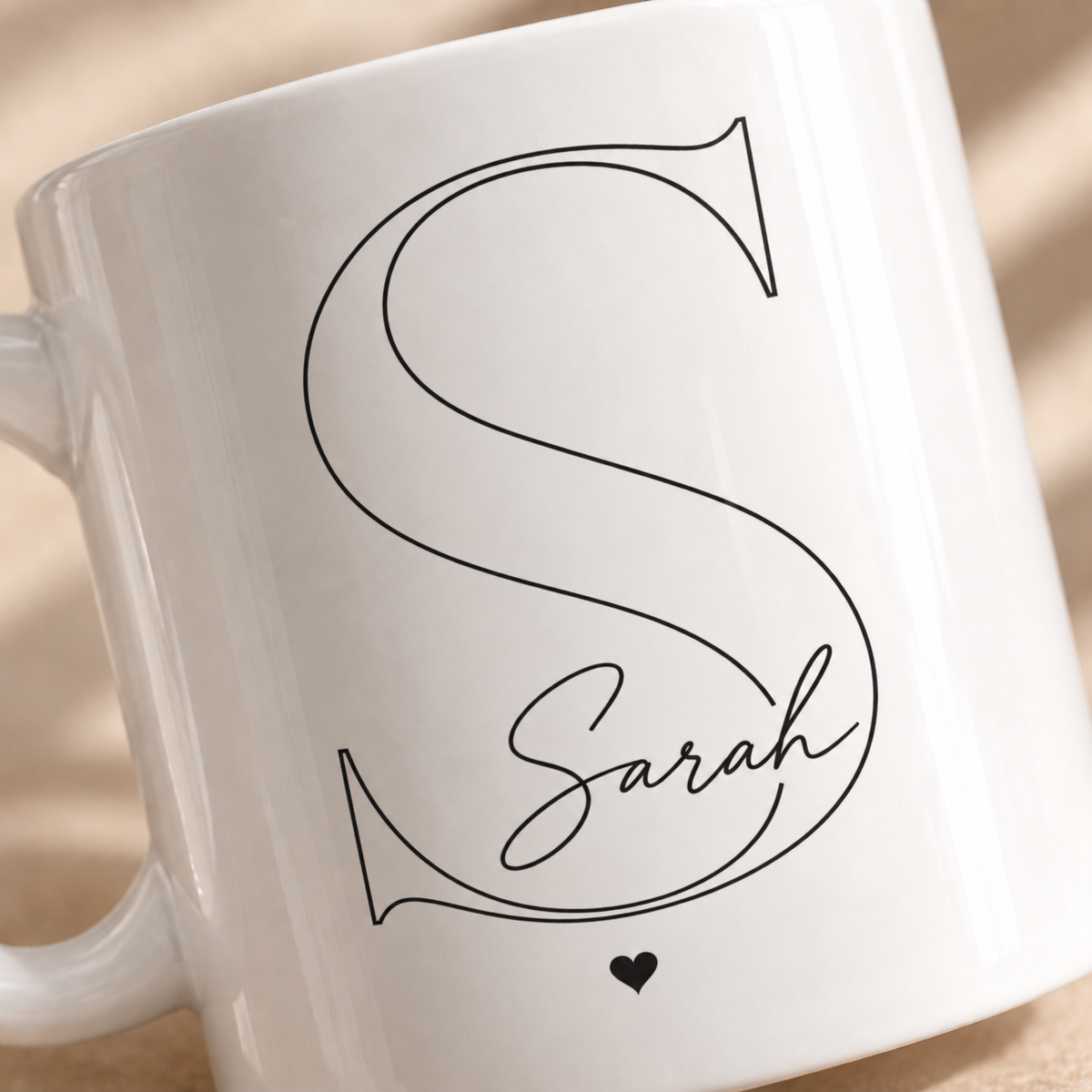 Close up of custom initial mug with personalized name and heart
