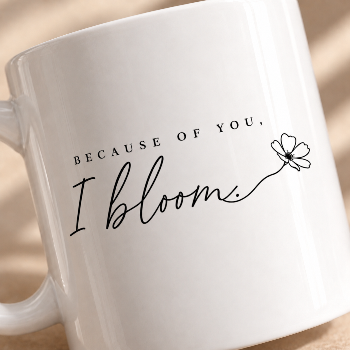 Close up of Because of You I Bloom mug with handwritten floral design
